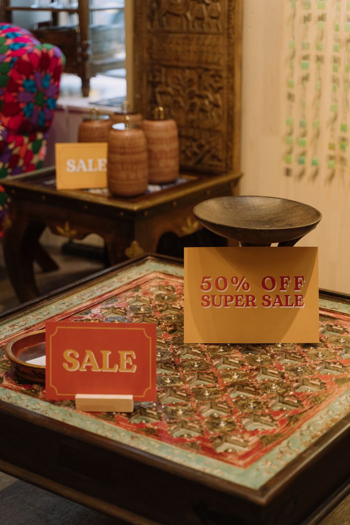 Mastering the First Impression: Your intriguing post title goes here Elegant in-store display with 50% off super sale signs on a decorative table.